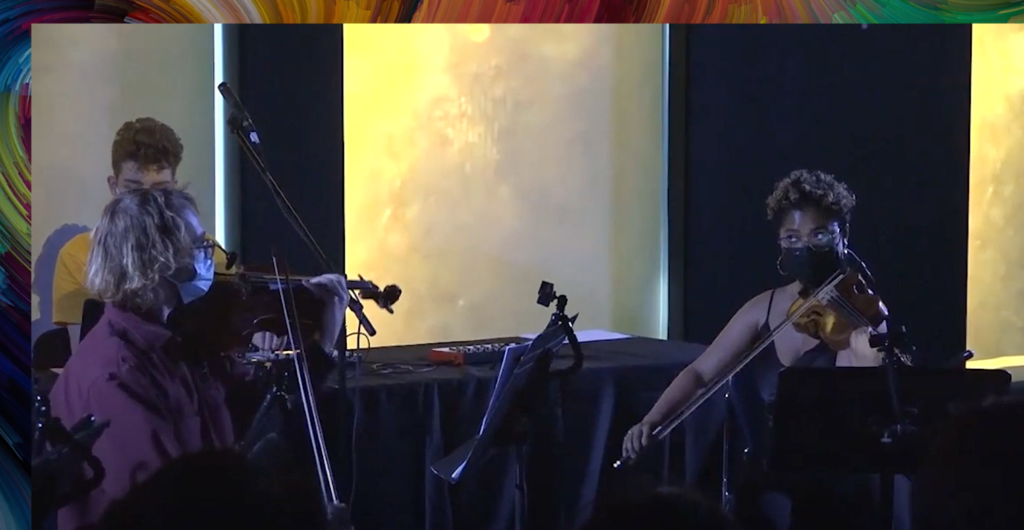 Two mic'ed string players perform with Jonathan.